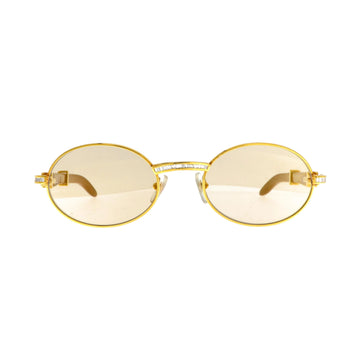 Cartier Must de Giverny sunglasses with gold front and diamond accents, featuring stylish, oversized design and dark tinted lenses.