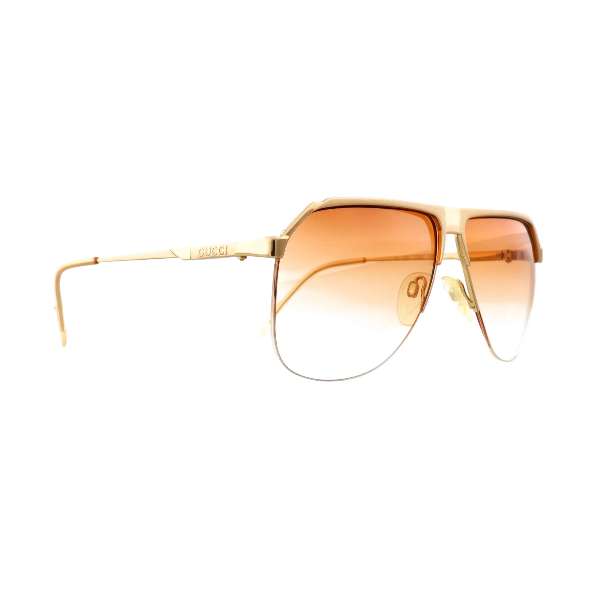 Gucci GG 1202 sunglasses with gold frame and dark lenses, stylish eyewear with sleek design and brand logo accents.
